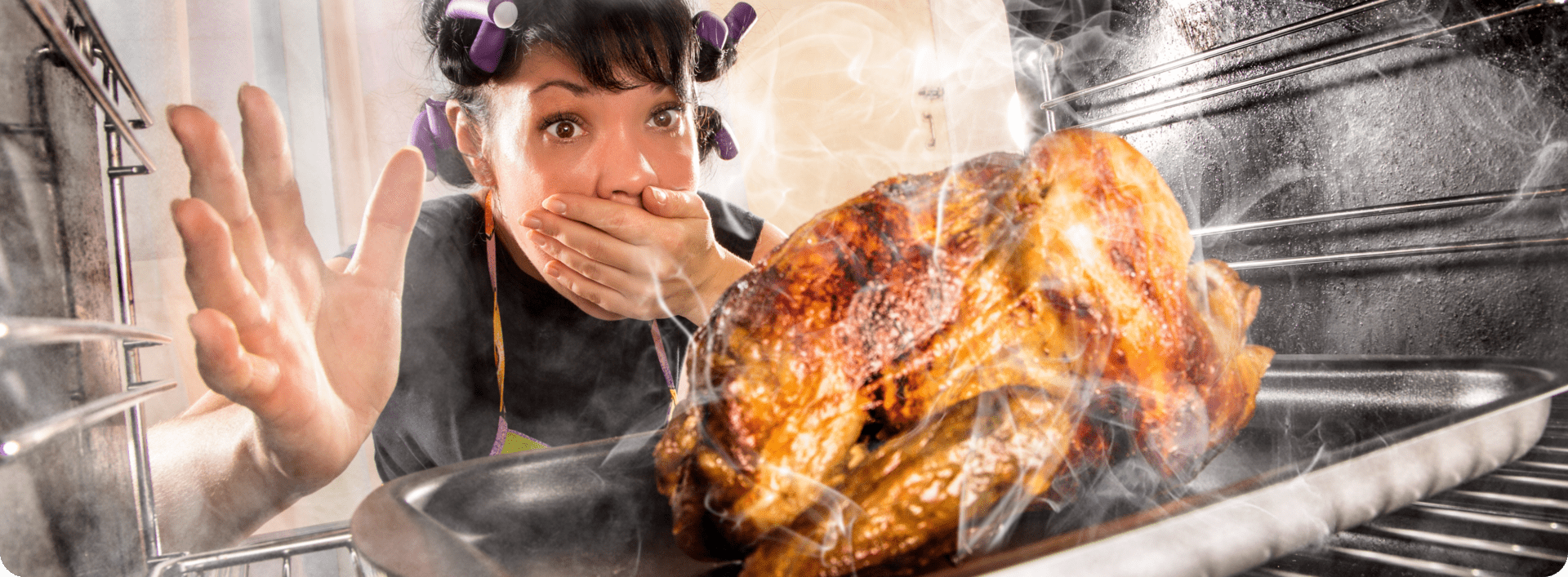 Surprised woman with roast turkey in oven.